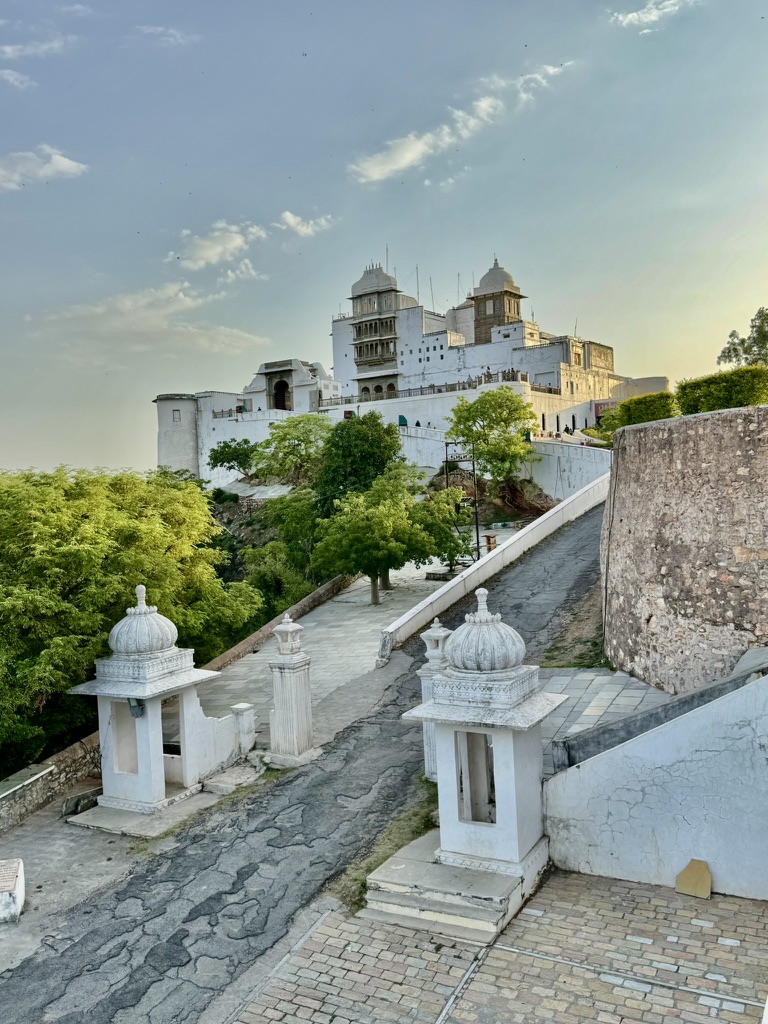 Weißer Palast über grünen Bäumen unter blauem Himmel in Indien