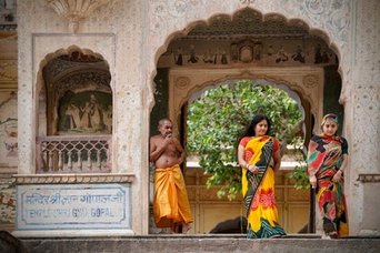Frauen in farbigen Saris unter einem reich verzierten Torbogen in Indien Frauen in farbigen Saris unter einem reich verzierten Torbogen in Indien