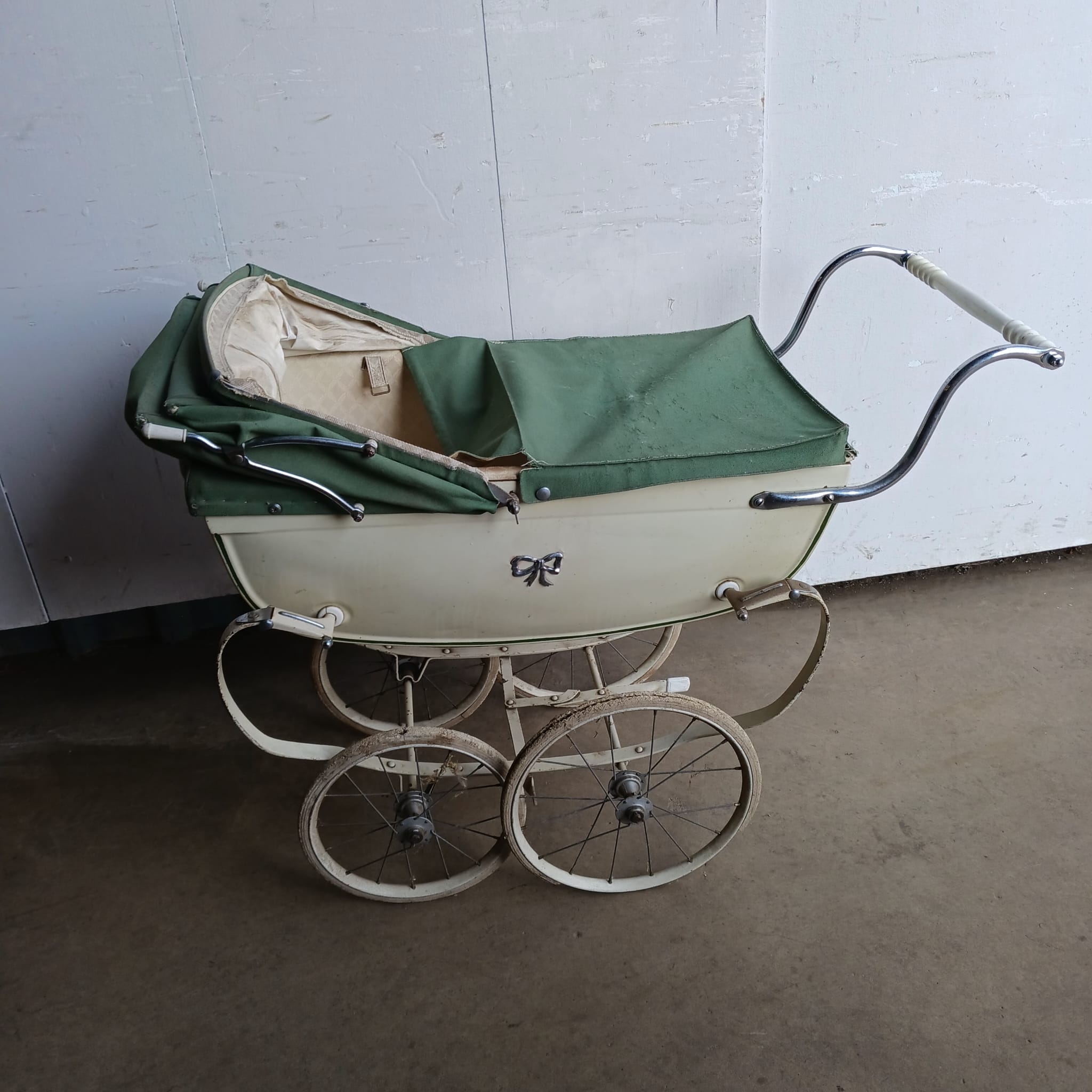 A small vintage Silver Cross pram
