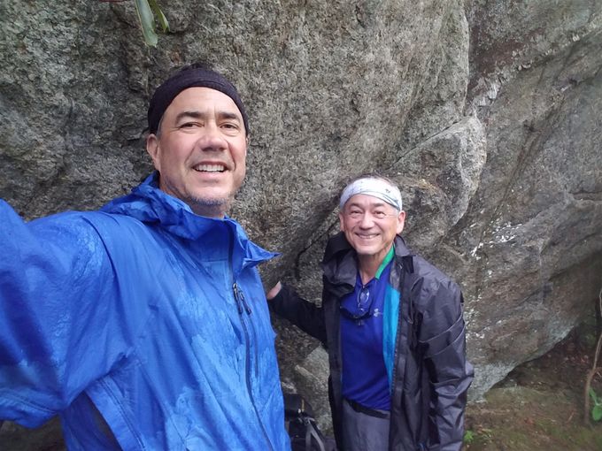 Taking cover from the rain under a rock ledge,