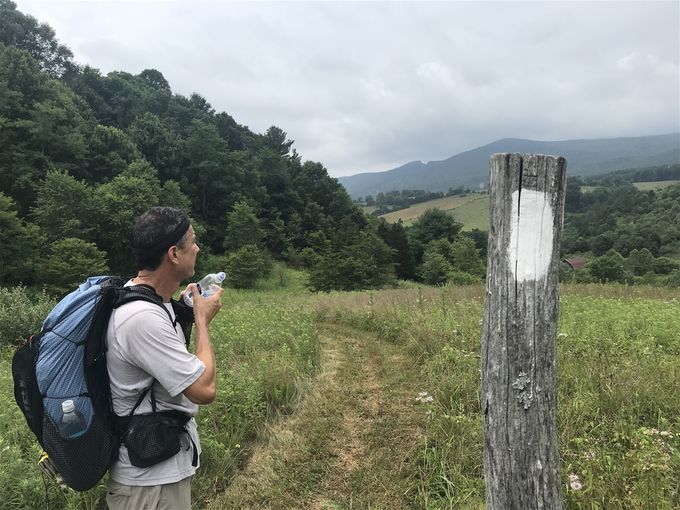 MacGyver checking out that ridge line in the distance which we will climb later in the day....also assessing the potential storm in the distance!