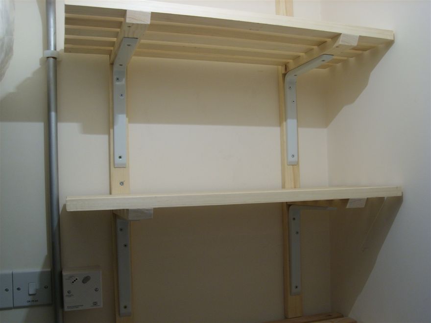 Shelving within a utility cupboard