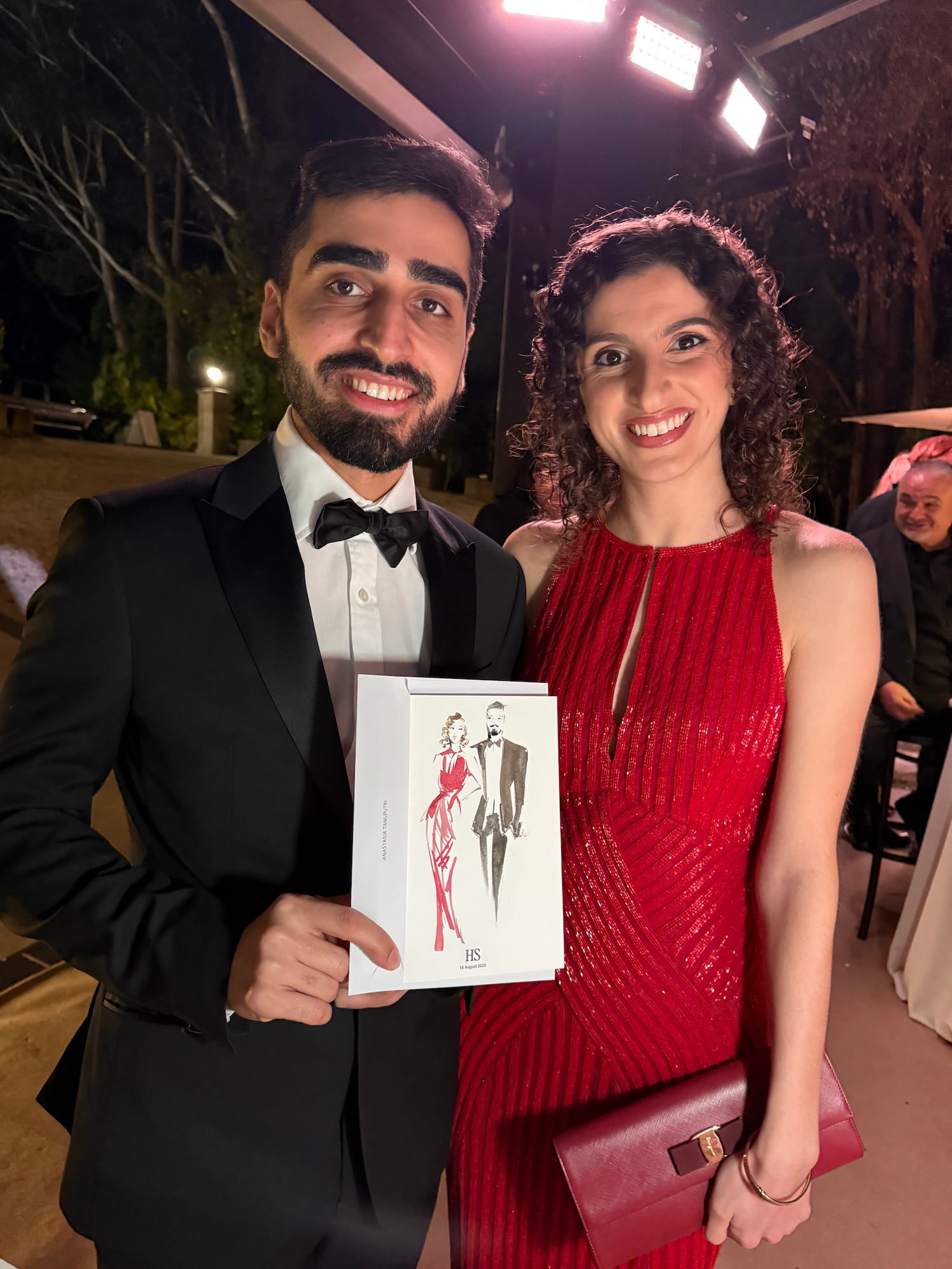 Wedding guests holding their live illustrated portrait created by Sydney wedding illustrator Anastasia Tanuputri 