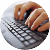 Two hands typing on a computer keyboard