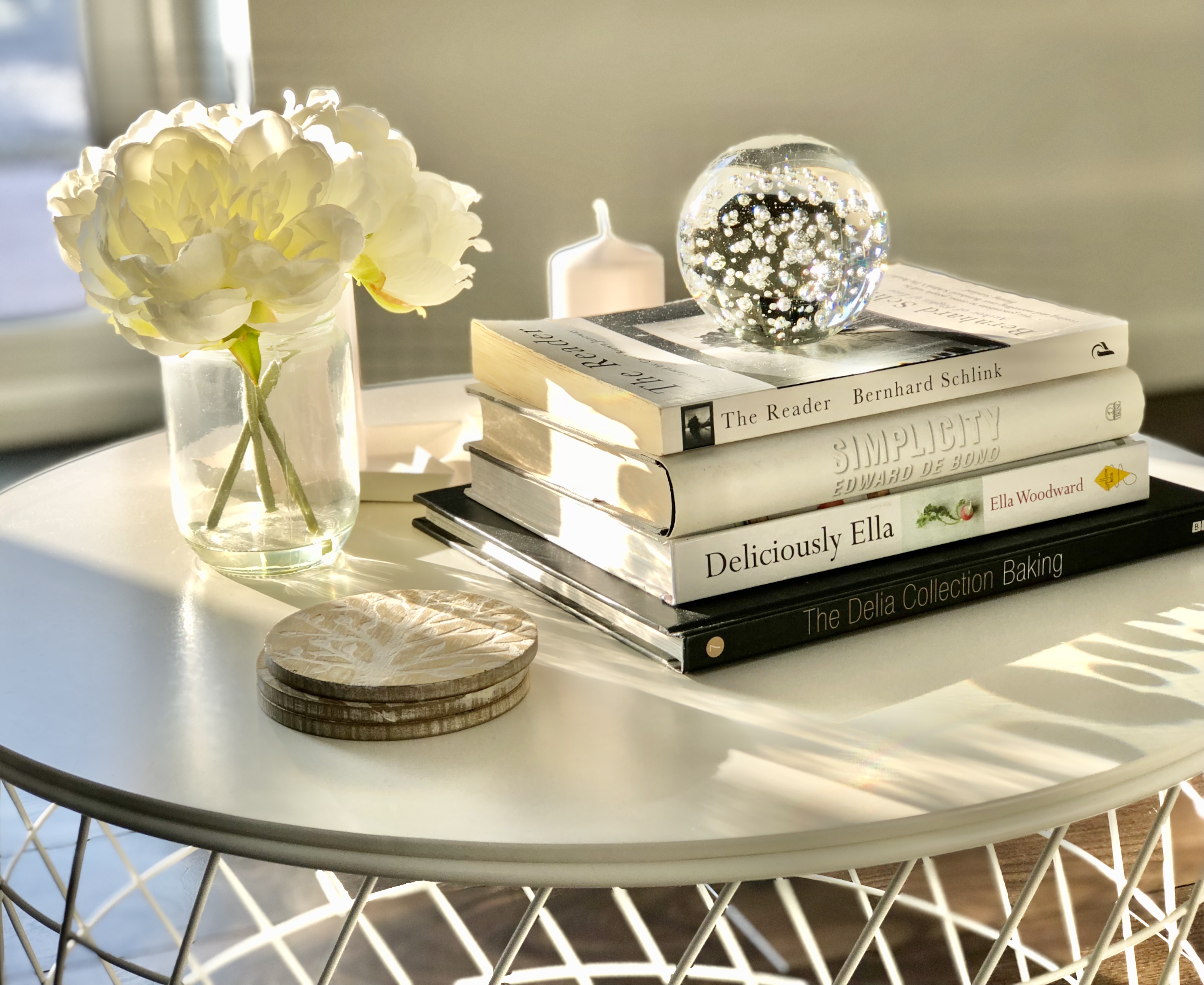 White flowers and books on coffee table
