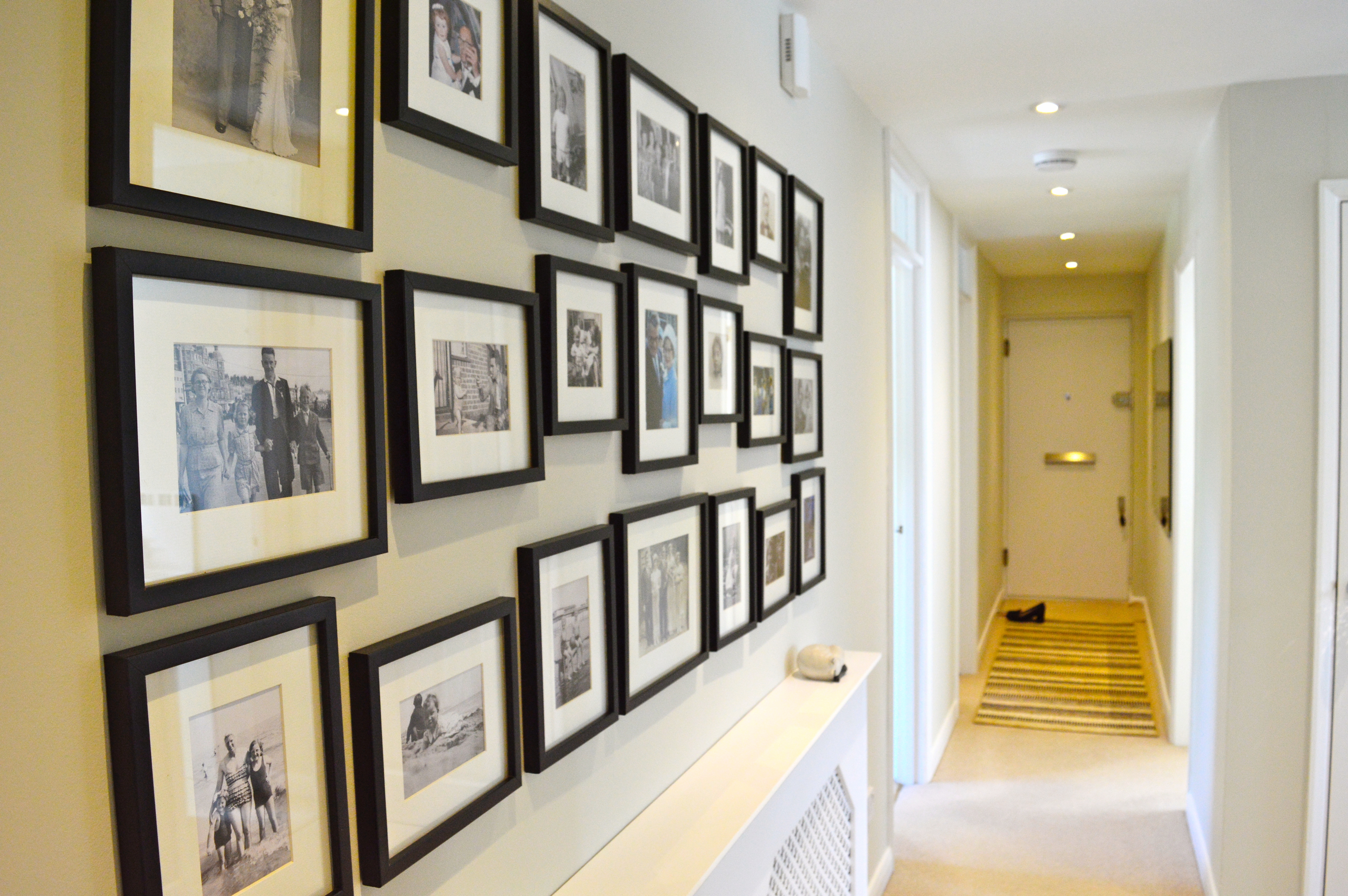 Entrance hall with family art wall in monochrome