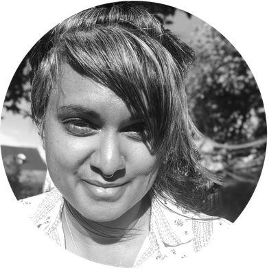 Black and white portrait photo with smiling woman.