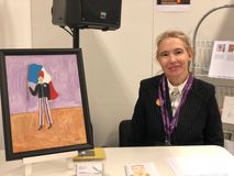 Carin Myrberg with her painting of  Armand Duboix