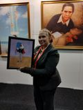 Carin Myrberg at Falun Gong exhibition with painting of Armand Duboix