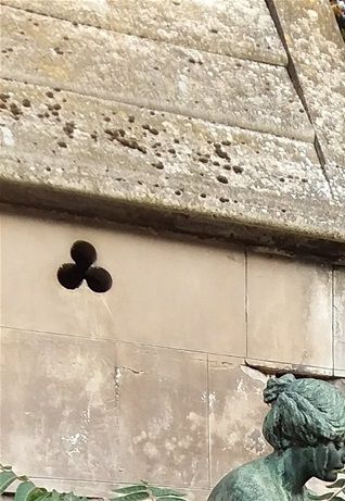 This grave site can be seen near one of the entrances of Père Lachaise cemetery in Paris.