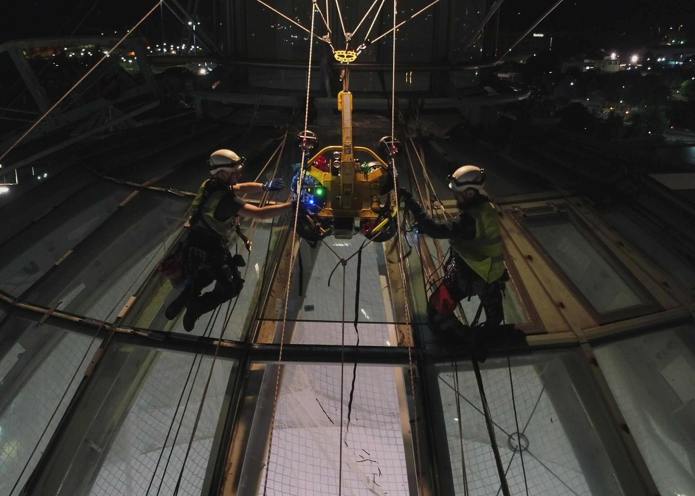 Abseilers on glass dome roof 