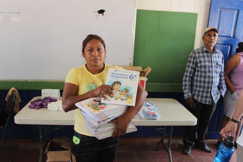 Donating text books to school.