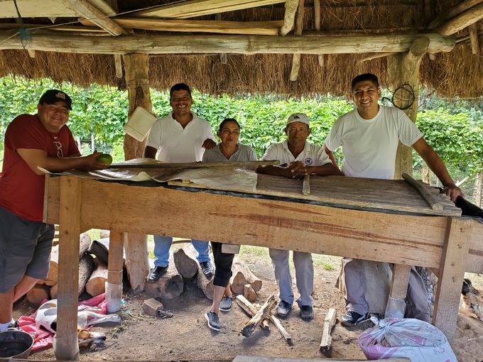 Some of the farmers in Nandarola show off one of their worm box fertilizer operations 