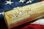 A picture of the U.S. Constitution on top of a U.S. Flag