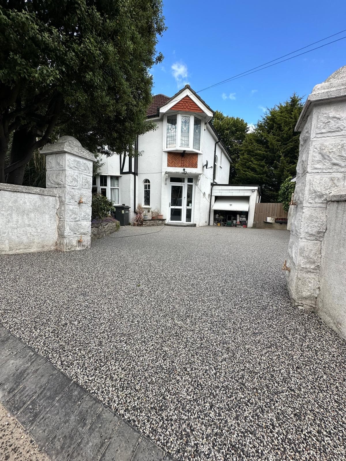 Resin‑bound driveway installation on Old Newton Road, Torquay, with grey blend finish and dark border detailing.