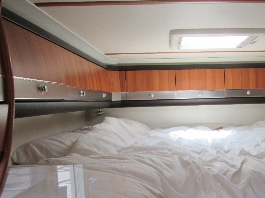 The transverse king-sized bed. The alternative layout being two singles running back to front on each side.