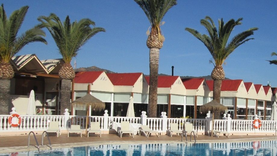 The outside pool area with the bar & restaurant in the background
