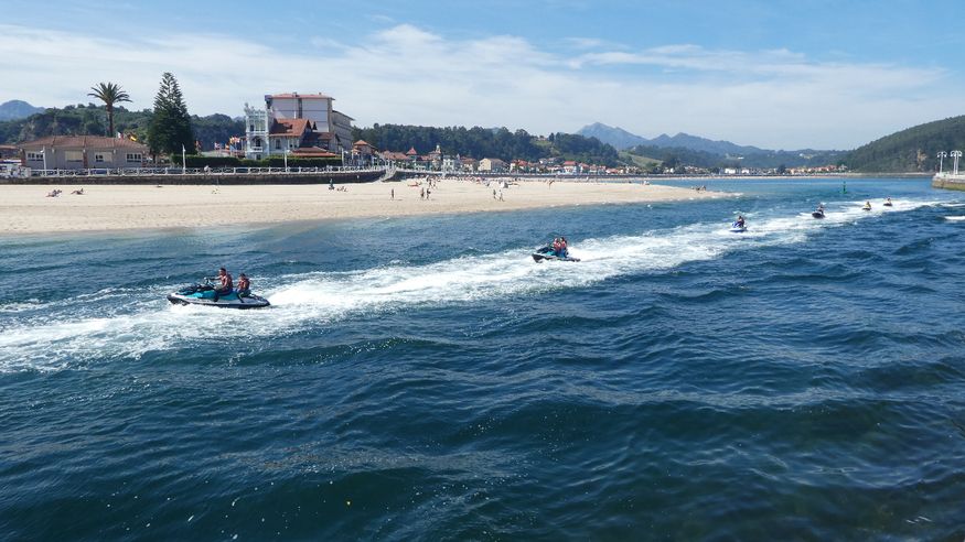 A group of jet-skiers return to the marina in line for safety reasons.