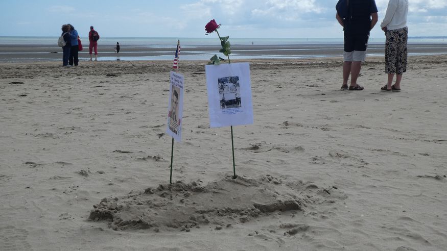 Tributes planted in the sand on the beach
