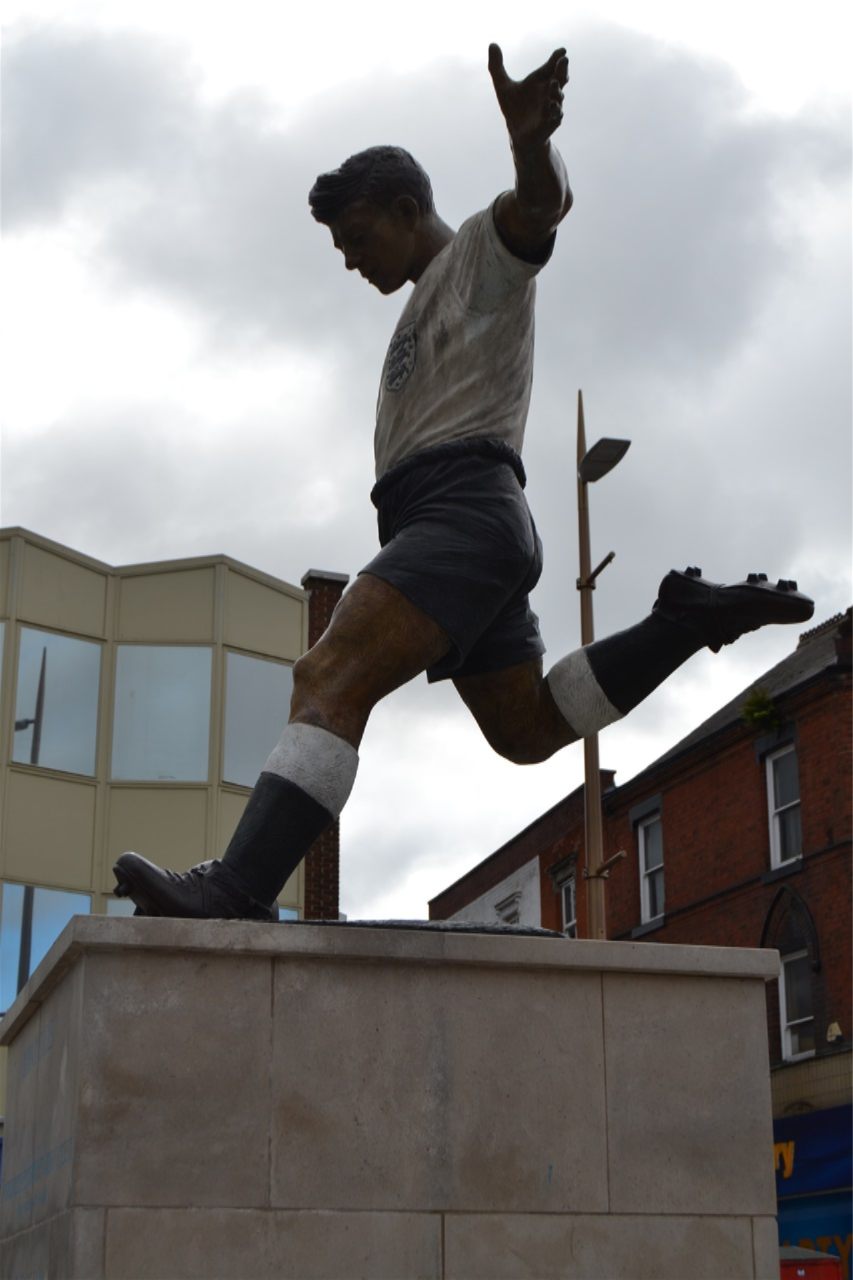Market place, Duncan Edwards, designed by James Butler in bronze, patinated. Mike Davis Foundry. Plinth designed by Steve Field, inscribed by Malcom Sier