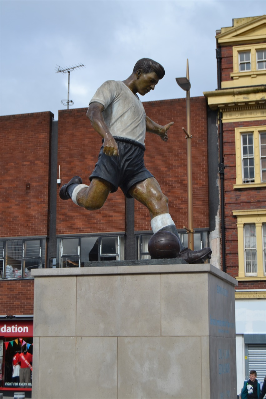 Market place, Duncan Edwards, designed by James Butler in bronze, patinated. Mike Davis Foundry. Plinth designed by Steve Field, inscribed by Malcom Sier