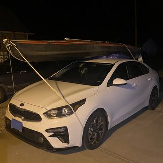 My kayak secured on the rental car