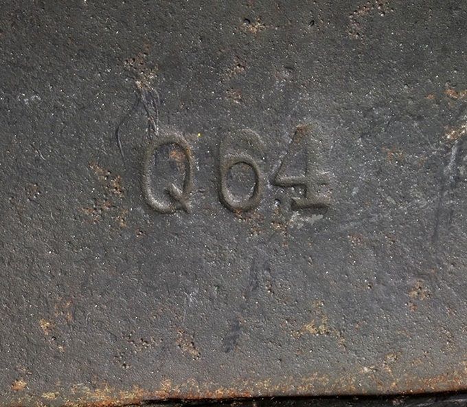 Manufacturing stamp from the Quist factory, Q64. The number 64 represents the number of centimetres around the edge of steel shell. This number can vary from 60 cm to 70 cm (there are some examples known which are even bigger). The Quist factory primarly manufactured M35 and M40 models however an extremely small number of M42s have been observed.