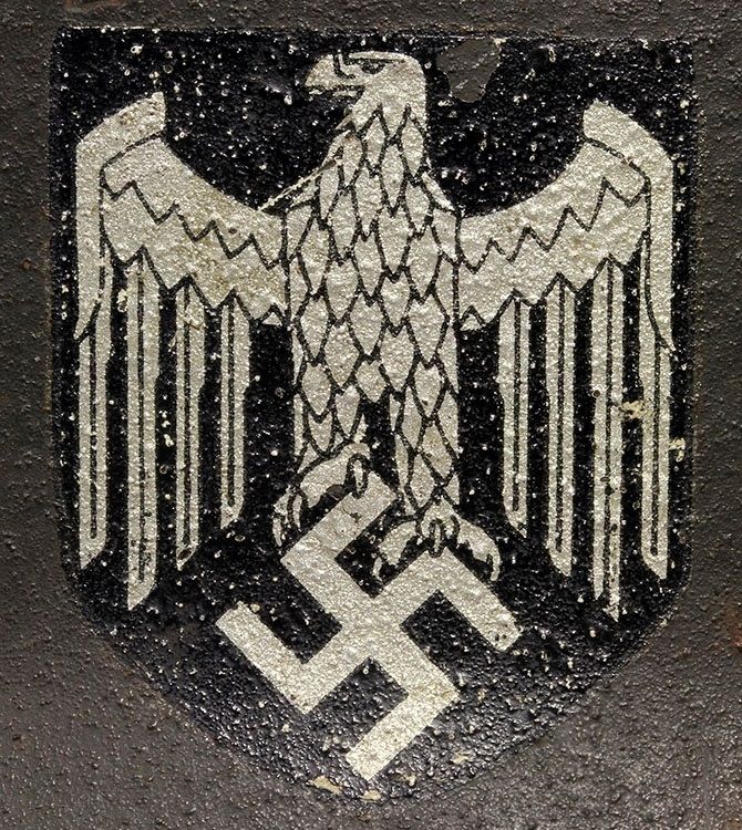 Decal on an M42 EF. This decal is a late HJ & K variant that differs with a thin left talon on the right foot. 
Classic Huber-Jordan & Koerner.