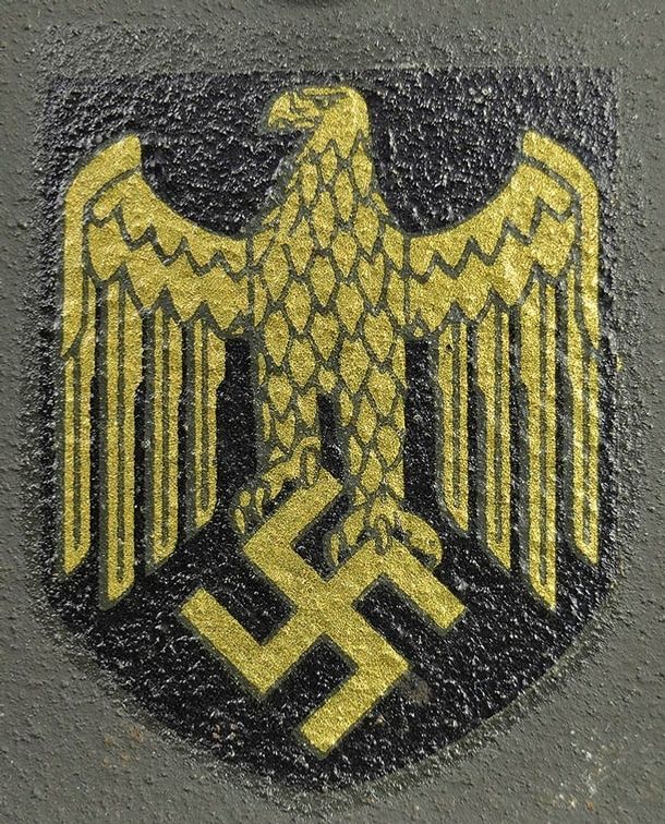 Kriegsmarine decal on an M40 Quist. The design is identical to an ET style Heer decal. This example exhibits a paler golden color. Notice the thick layer of lacquer that was applied to help prevent the decal from flaking off the surface. Heavy flaking of KM decals is common.
 