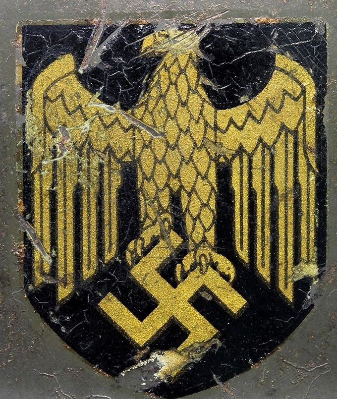 KM decal on an M35 ET. Notice the detail of the two-sheet construction that results in a border line around the eagle/swastika, particularly noticeable on the upper side of the wings at several locations. Design is the same as an ET style Heer decal.