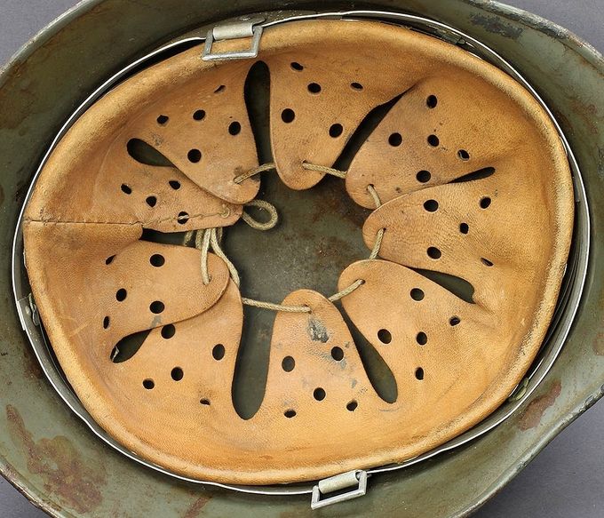 An aluminum single band liner. Note the bending at several places on the band which was caused by stress during wear. This is an early liner likely produced prior to 1938.