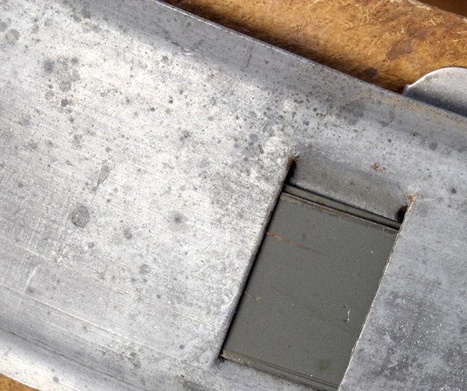 Notice the green steel leaf spring in the rectangular shaped opening in the steel band.