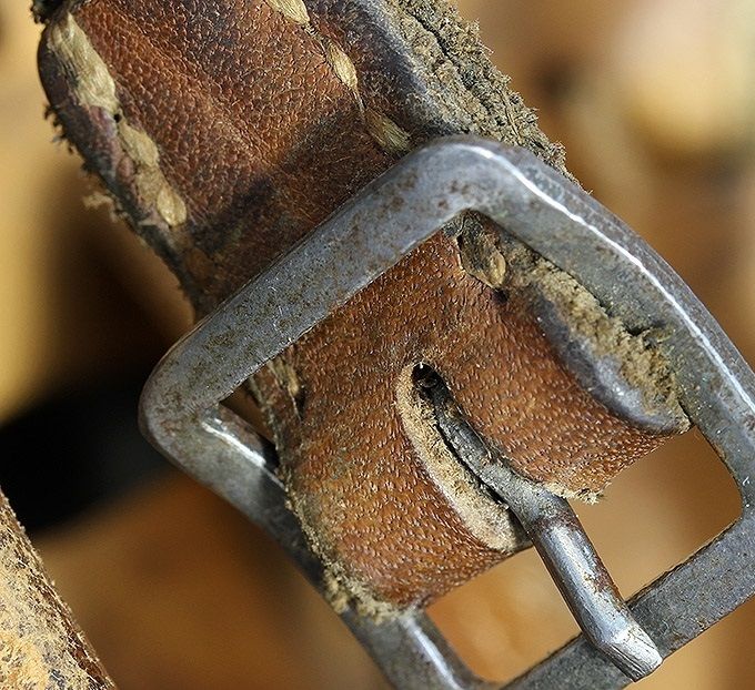 A buckle in brushed steel (not painted) on an M40 reissue. These are common on mid-war and late war helmets.