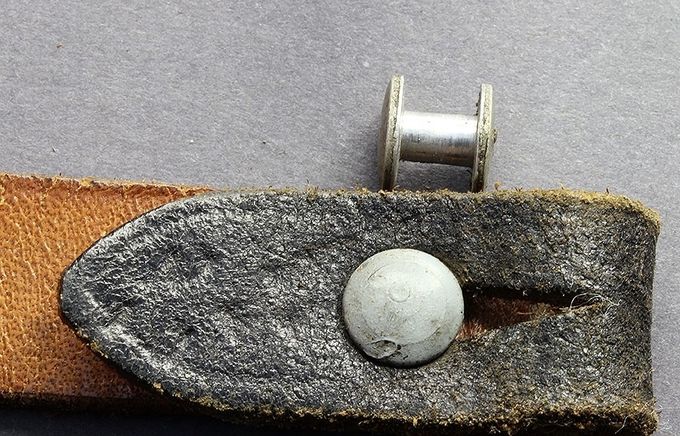 An aluminum retaining stud (above) and a zinc-coated steel stud (below).