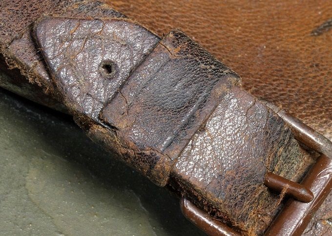 A brown painted early roller buckle on an M18 transitional.