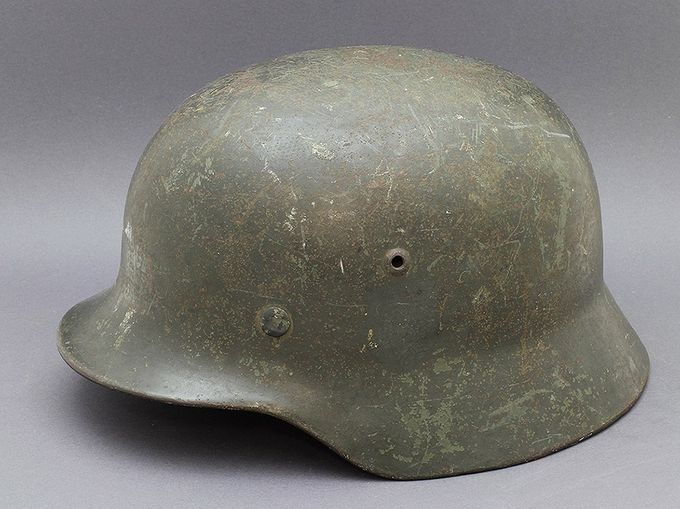 M35 ET68 repainted with an airbrush. The decal is hand-painted over with a thick layer of the same paint. 
Notice the factory paint in areas where the repaint has worn off.