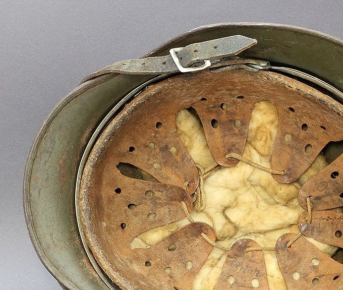 The liner of the M35 above. This helmet is named 3 times in the rear skirt and once in the leather. Under the liner the soldier placed some housing insulation material to provide warmth. This is WW2 era material.