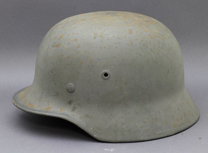 M40 Q66 with shipboard gray paint. The paint layer is thin and corrosion/rust bleed-through is evident.
