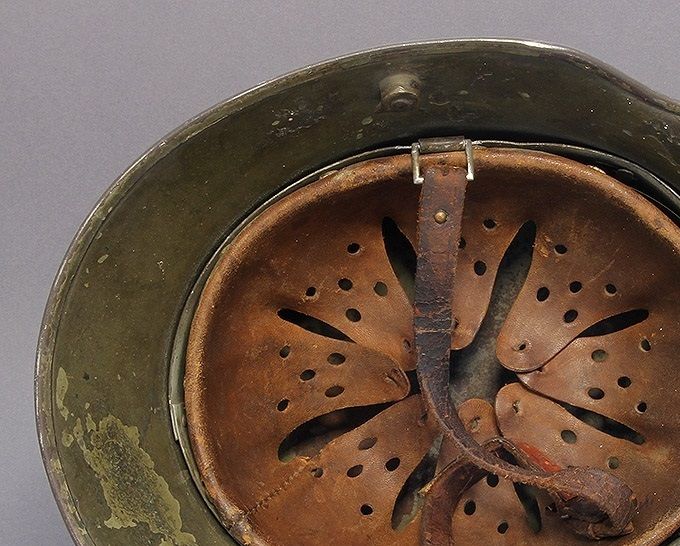 The liner of the M16/M17 above. Early M31 liner with embossed maker stamp and early roller buckle chinstrap.
