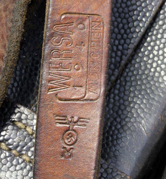 A Kriegsmarine (Navy) marking on a Y-strap. The KM marking is pictured with an eagle with swastika on top of capital letter 