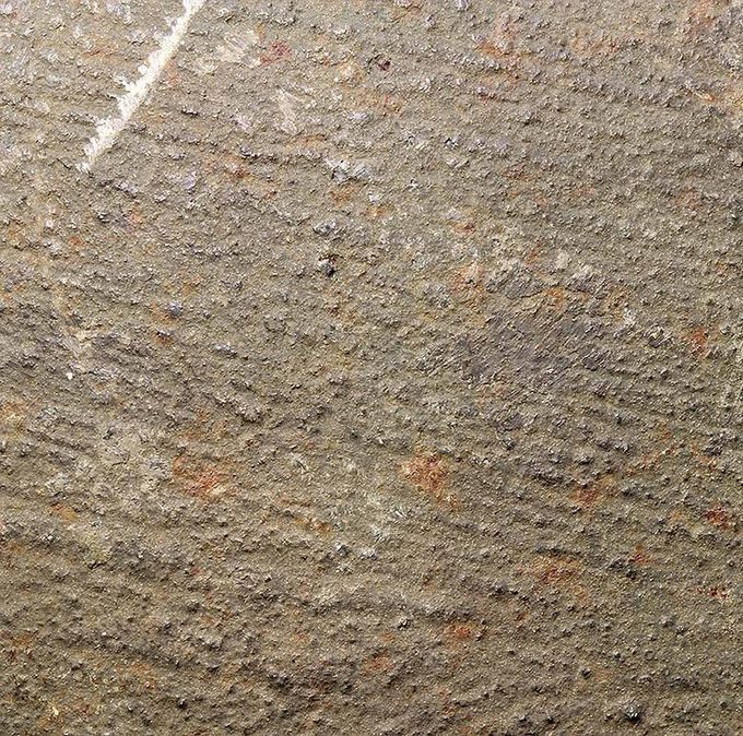 The paint structure of the M35 helmet above. Rough hand-brushed paint strokes in green-gray.