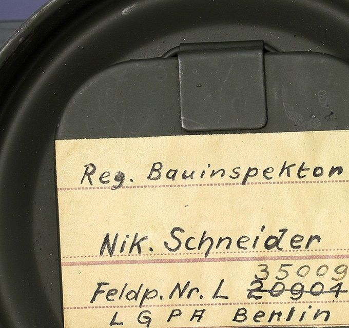 Naming on the inside of the cover of a gas mask canister. 