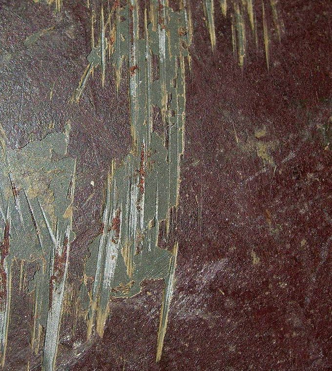 Close-up picture of the top side of the helmet. Notice the smooth green factory paint beneath the tan and brown camo paint.