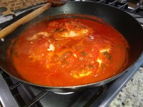 Stuffed calamari simmering in marinara sauce.