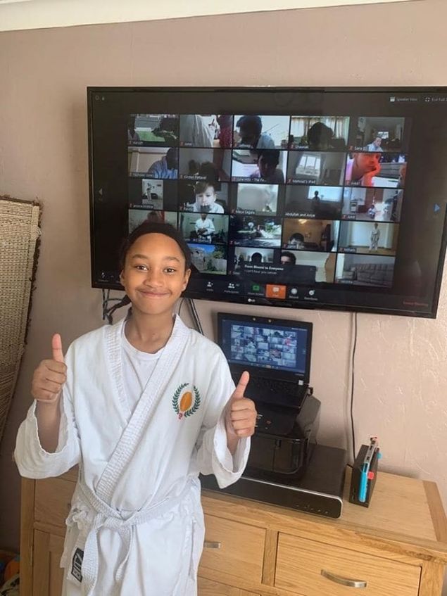 JKS Harrow and Kingsbury hosted the world's (we believe) Online Live Kata Tournament. 50 students from 5 clubs competed in this ground breaking event. 
Students from JKS Harrow, JKS Luton, JKS Bradford, Shinri Milton Keynes and SSKI Watford battled it out in their living rooms and gardens 
The photo above shows one of the students from JKS Luton and the Zoom screen getting ready for the competition.

Results
6-8 yrs old Beginner to 7th Kyu
1) Dev - Harrow
2) Saanvi - Harrow
3) Amit - Harrow
6-8 yrs old 6th Kyu +
1) Aarush - Harrow
2) Sami - Harrow
3) Safa - Bradford
9-12 yrs old Beginner to 7th Kyu
1) Michael - Harrow
2) Shaunak - Harrow
3) Indy - Luton
9-12 yrs old 6th Kyu +
1) Lucy - Luton
2) Vaajas - Harrow
3) Rasel - Bradford
Cadets Beginner to 7th Kyu
1) Alex - Harrow
2) Rudraksh - Harrow
Cadets 6th Kyu +
1) Laksh - Harrow
2) Samir - Bradford
3) Jatheep - Shinri
18+ 10th to 4th Kyu Mixed
1) Divyesh - Harrow
2) Hendrik - Luton
3) Vivek - Harrow
18+ Female B&B
1) Vicky - Watford
2) Helen - Harrow
3) Kirsten - Bradford
18+ Male B&B
1) Jason - Harrow
2) Robin - Bradford
3) Suri - Harrow
40+ Mixed Kyu Grade 
1) Vivek - Harrow
2) Teresa - Harrow
3) Tazeem - Bradford 
40+ Mixed Black Belt
1) Kirsten - Bradford
2) Robin - Bradford
3) Suri - Harrow