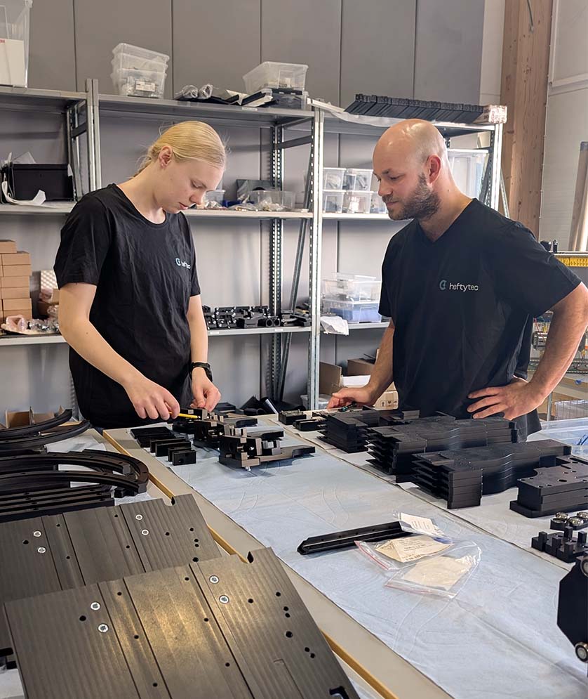Technicians inspecting machined parts