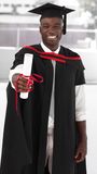 Man smilling at university graduation celebration