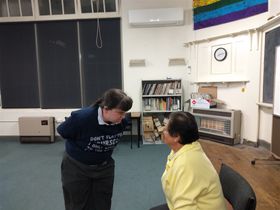 Sarah interrogates Robyn during an improv.