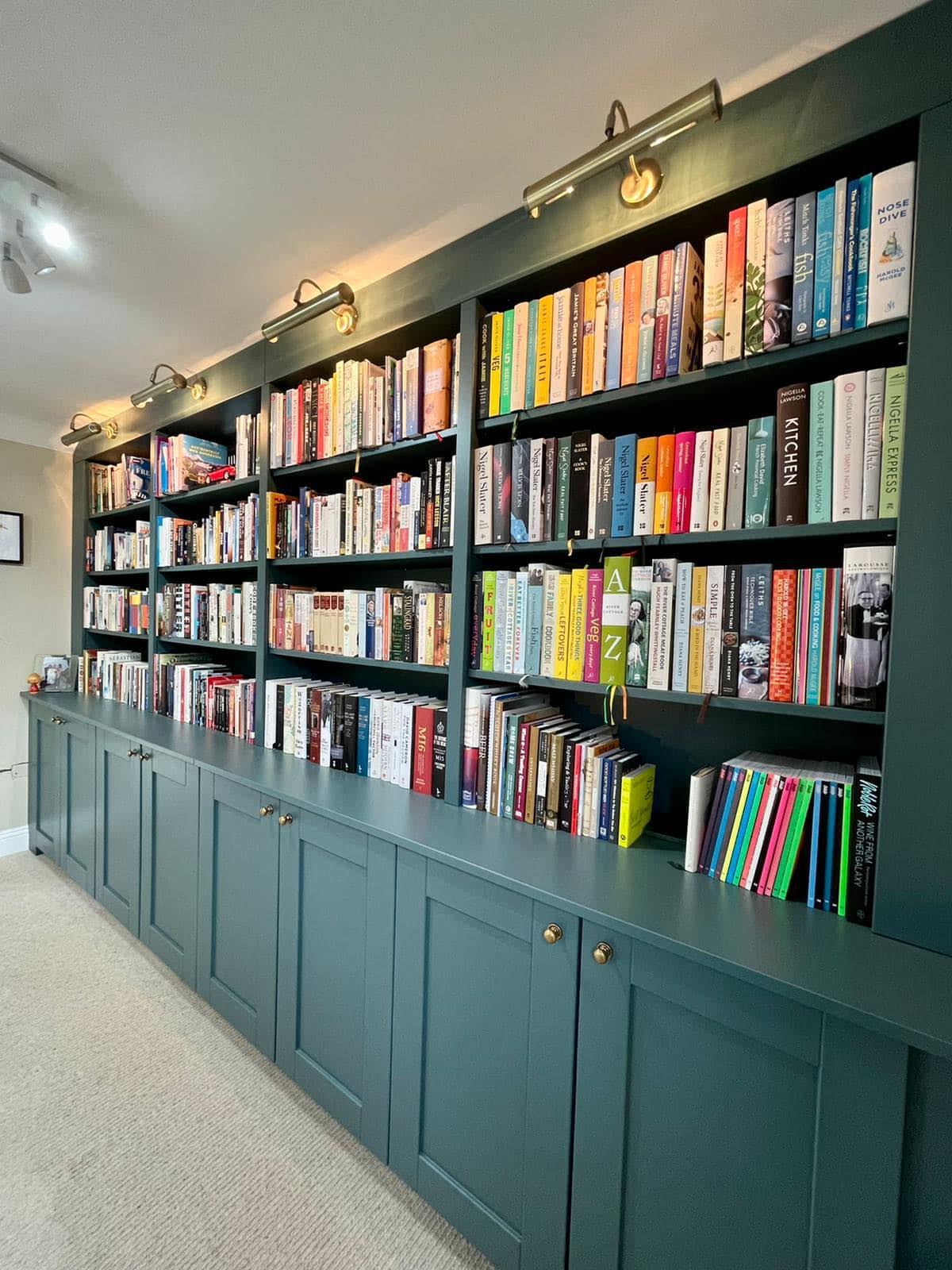 Blue bookself with cupboards installed by Jamie's Interiors