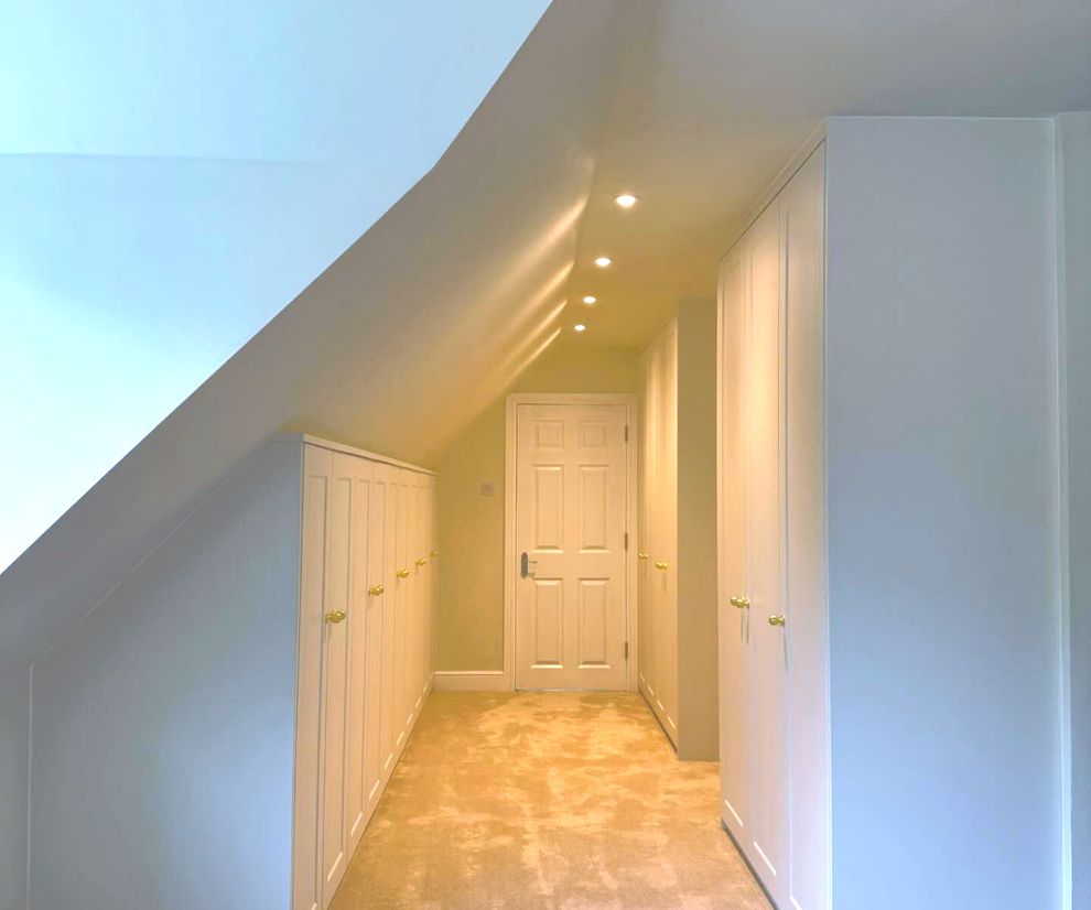 white angled wardrobe with brass nobs